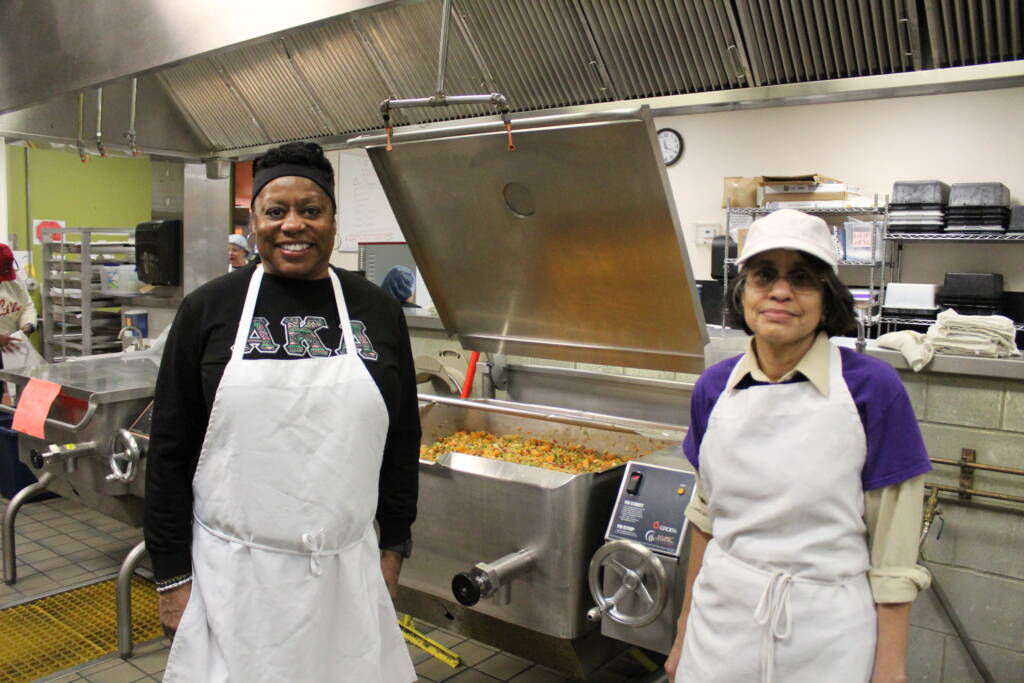 Board members volunteering in the kitchen