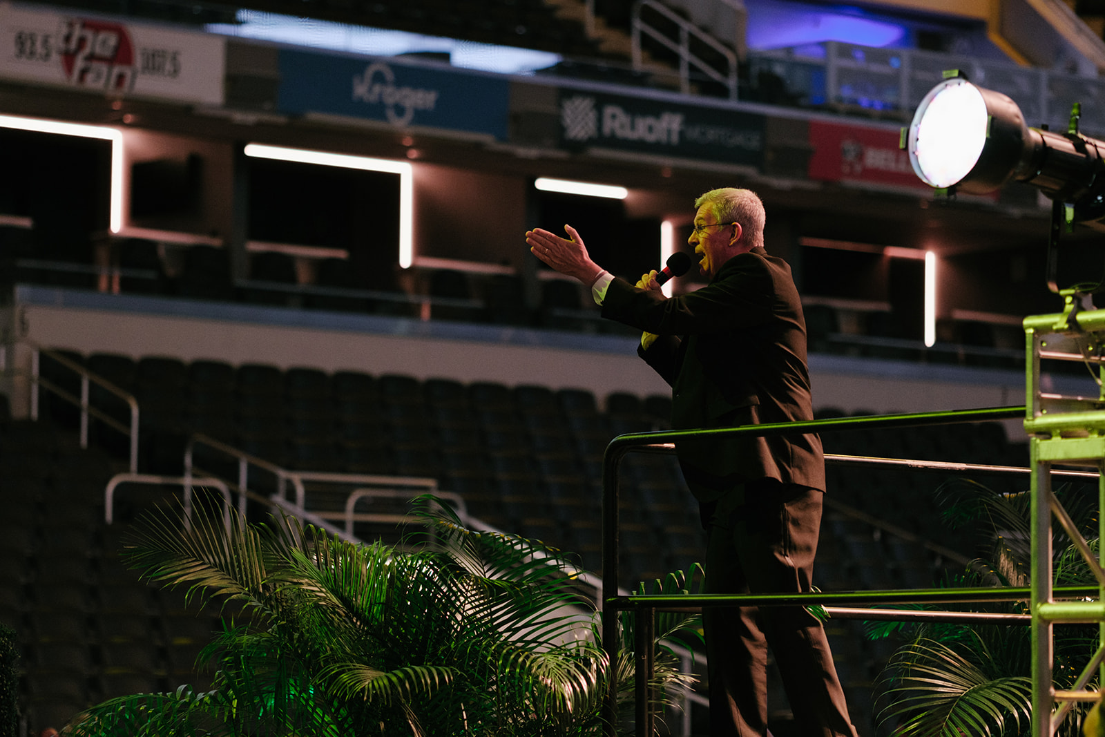 Man with a microphone announcing on stage